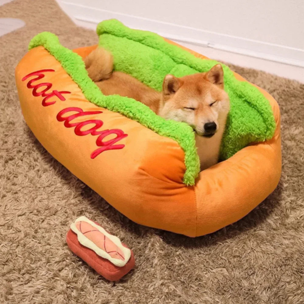 Dog resting in a hot dog-shaped pet bed